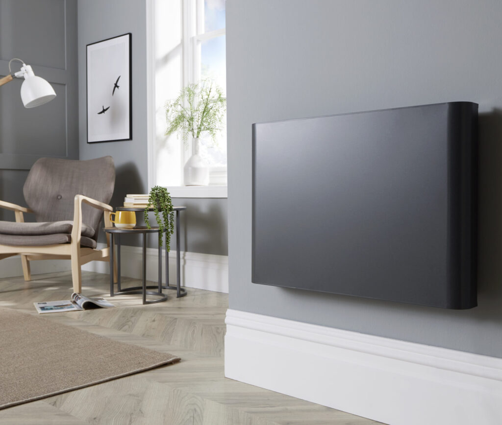 Main product image of the Ecopanel XT Anthracite Electric Radiator wall-mounted in a modern lounge setting.