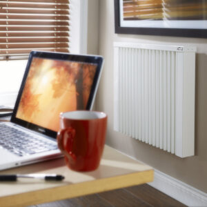 Image showing a German Aeroflow Electric Radiator wall-mounted in a home office setting.