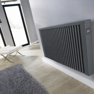 Image detailing the Aeroflow AF05E in anthracite grey finish. The electric radiator is wall-mounted in a modern lounge room with grey decor. The image illustrates the LCD touch display controls.