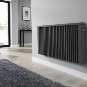 Image of Anthracite Grey Aeroflow Electric Radiator by Electrorad. The Radiator is installed in a modern lounge with neutral grey decor. The touch-screen control is visible on the side of the radiator. Side-mounted controls mean that the radiator can be reversed, to allow installation either way around. As the radiator is reversible, the controls and power cable can be located either-side for easy installation and total flexibility.